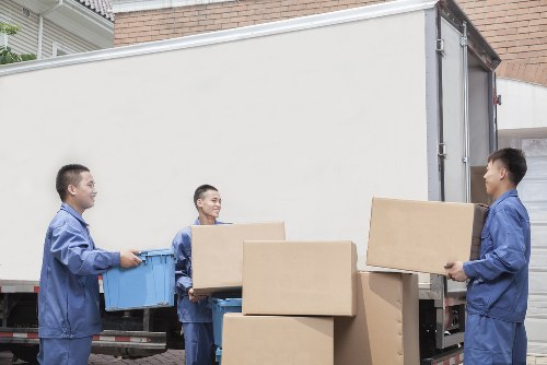 Professional movers loading boxes and furniture carefully