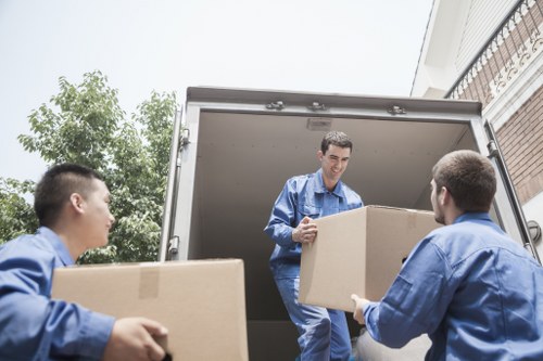 Man with van removal service loading boxes in a German city street