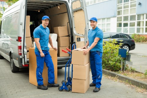 Mover using protective gloves and handling equipment during loading