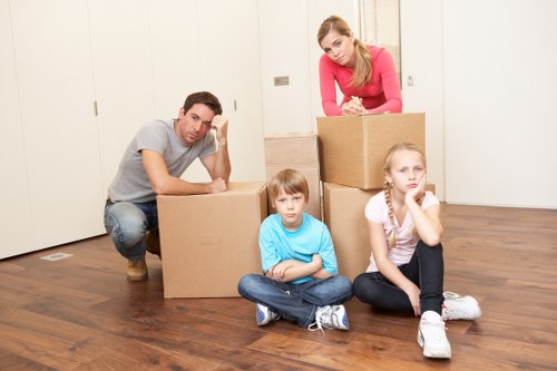 Moving crew handling furniture in a German apartment building