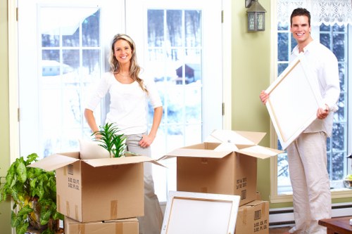 Worker taking a safe lifting pause during a house move